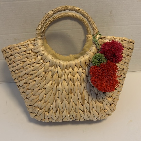 Straw Handbag has Red/Green Straw Pom Pom Tan Cloth Interior Draw String Closure - Picture 1 of 10